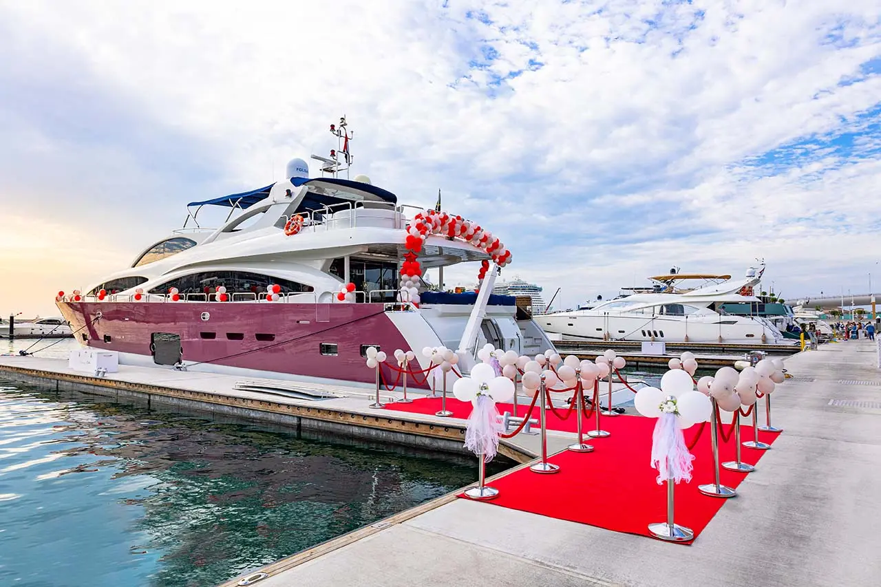 A yacht with wedding decorations docked at Dubai Marina