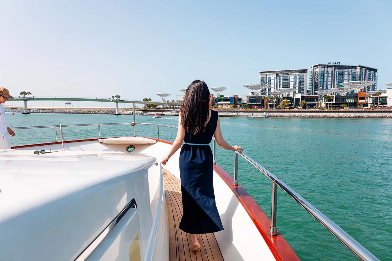 A woman standing on a yacht