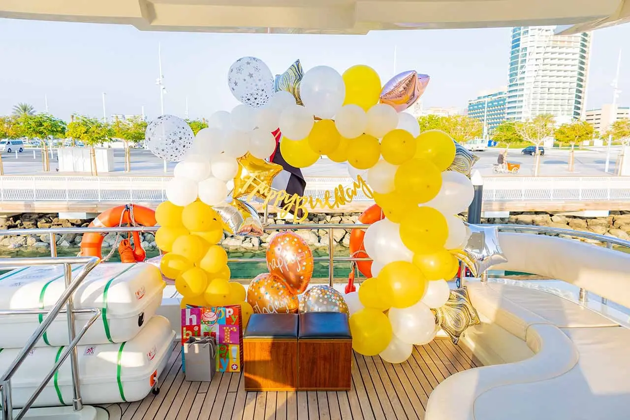 A yacht decked out with birthday decorations pulls up to the Dubai Marina