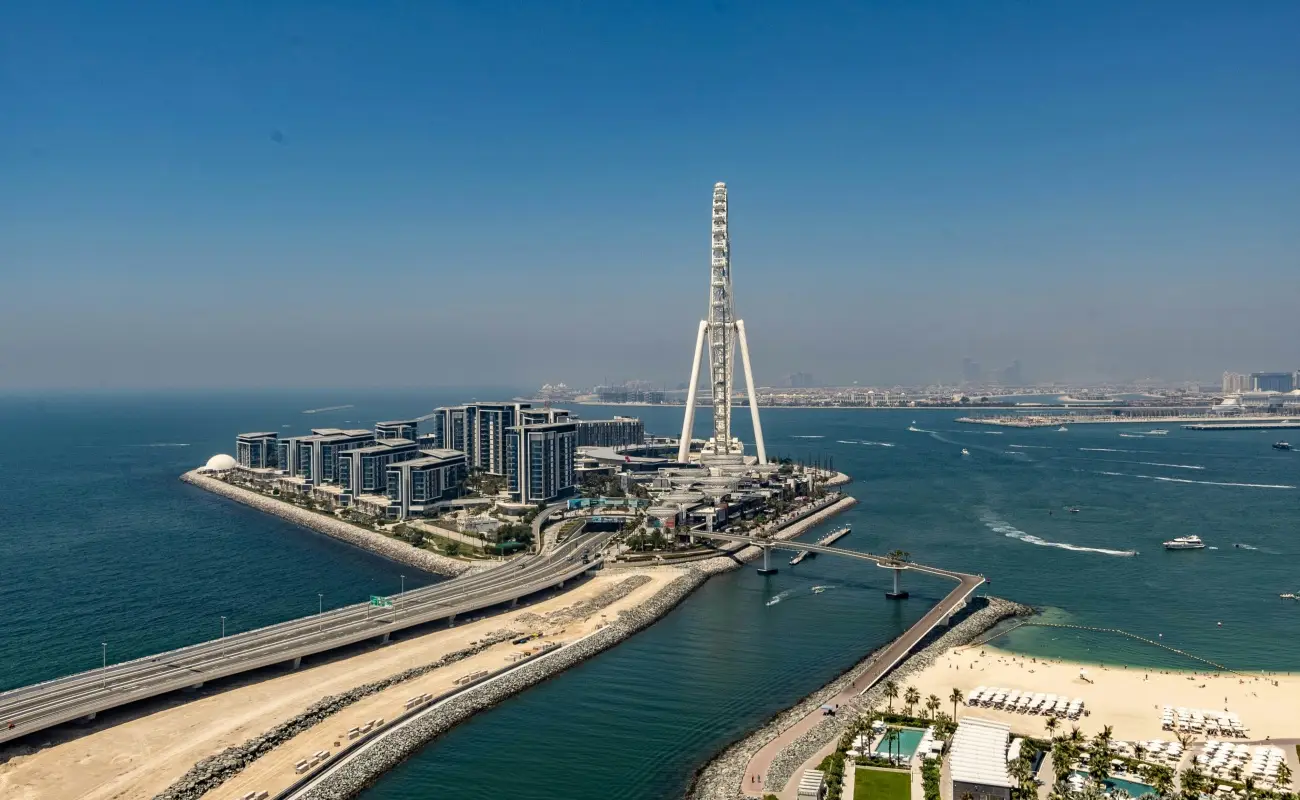 Dubai Harbour with Ain Dubai and modern waterfront buildings.