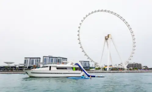 during the dubai marina water slide yacht cruise, the iconic ain wheel comes into view along the route.
