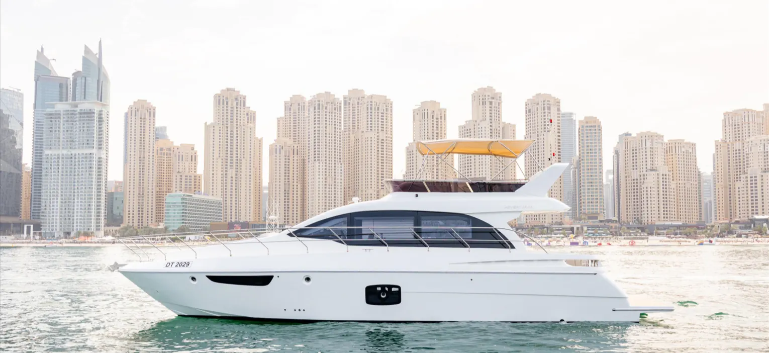 your sunset yacht cruise begins with this sleek yacht docked at dubai harbour, ready for a golden dusk sail.