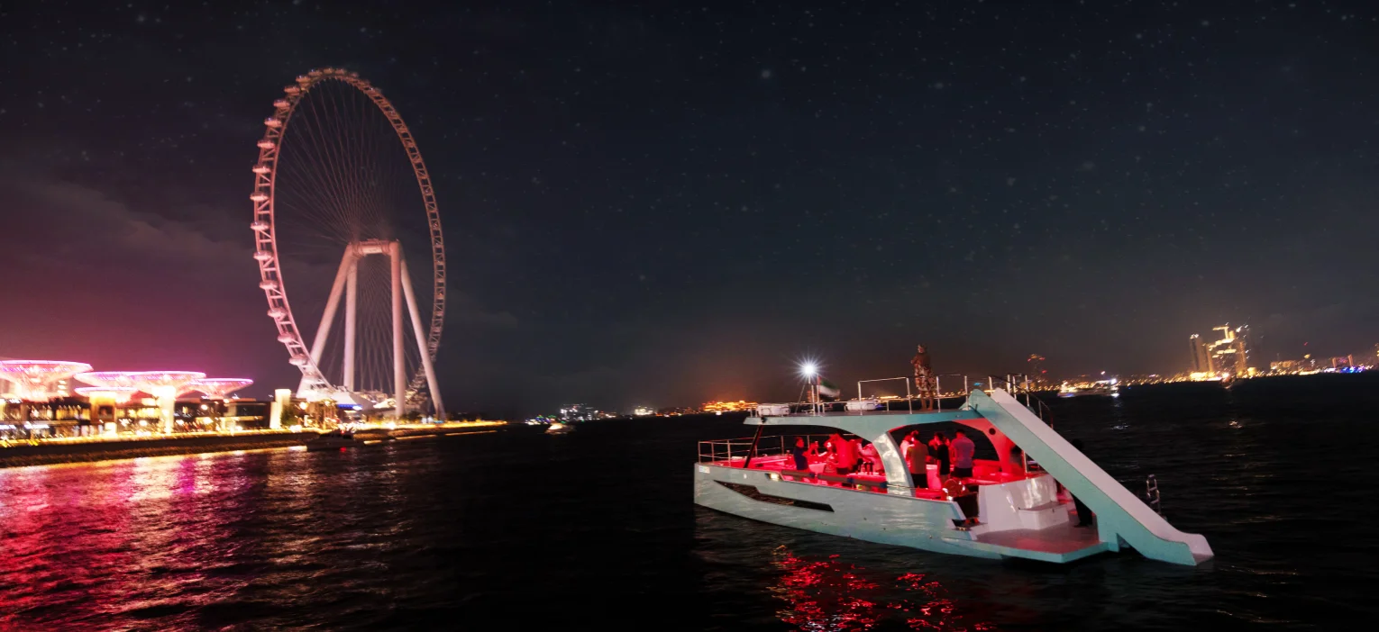 dubai city skyline at night, viewed from a dubai harbour yacht ride