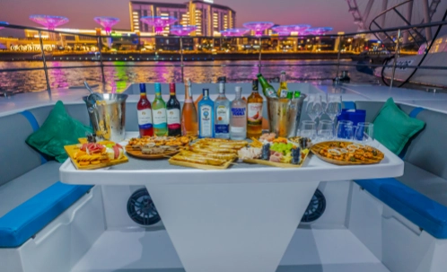 guests dining on the yacht deck at night, a moment from an evening yacht cruise