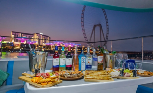ain dubai ferris wheel at night, seen during an evening yacht cruise