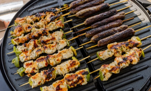 fresh bbq skewers being grilled for dinner service on dubai harbour couples yacht cruise