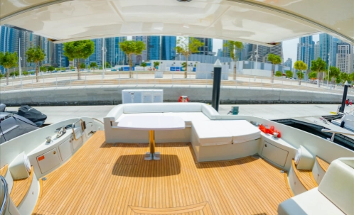 relax in the spacious, modern lounge area of our shared boat during your dubai marina boat tour, complete with comfortable seating and a premium sound system to enhance your 1-hour cruise with drinks included.