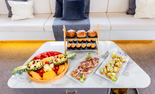 a delicious spread of savory dishes, fresh salads, and baked treats is served aboard the yacht, part of the included bbq lunch for the dubai harbour yacht tour.