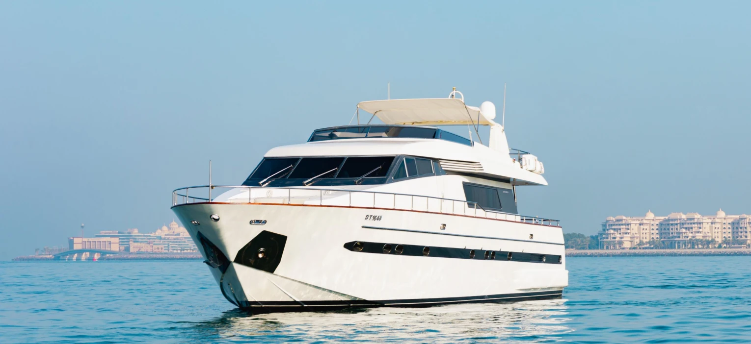 luxury white yacht sailing in dubai harbour, ideal for a dubai shared yacht tour with family, offering a memorable shared marine experience with breakfast included