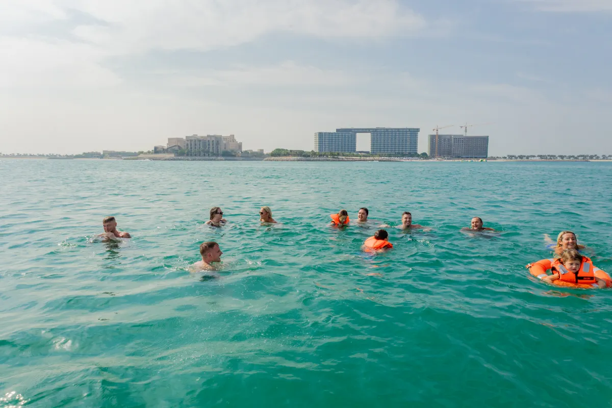 Dubai sea water temperature guide showing swimmers enjoying warm coastal waters